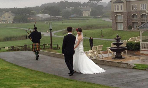A bagpiper and a bride and groom.