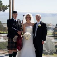 Picture of a bride, groom and bagpiper in San Francisco